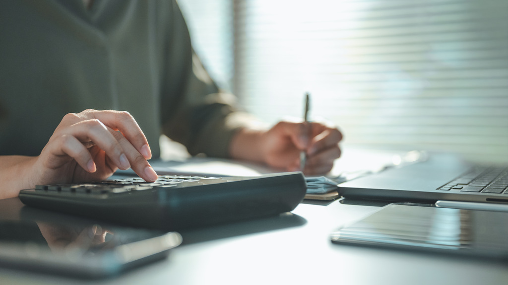 pessoa calculando quanto rende 1 milhão em seus investimentos.