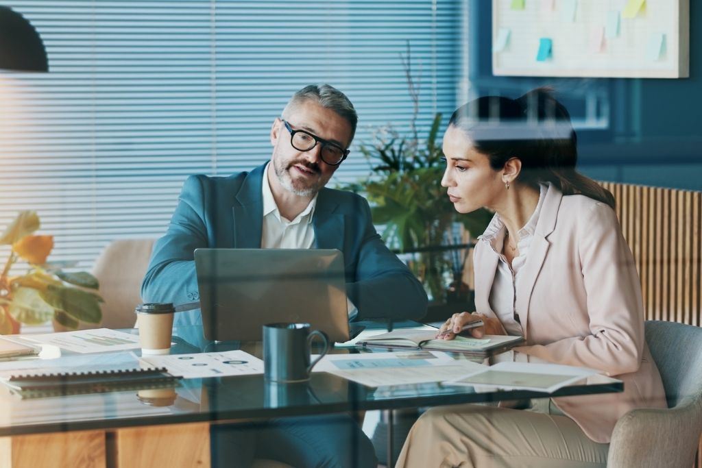 Homem e mulher em escritório, representando as características do investidor profissional.